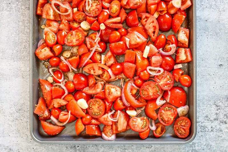 tomatoes cut up, on a baking sheet
