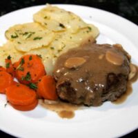 a salisbury steak meal on a dinner plate