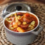 a small cocotte with smoked sausage and butternut squash stew
