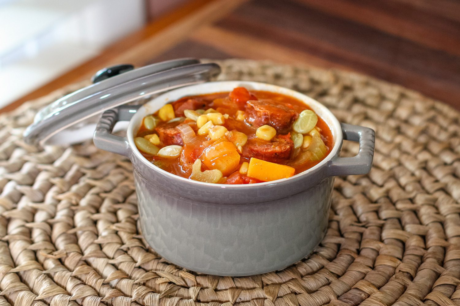 sausage and butternut squash stew with tomatoes and corn in a serving size cocotte