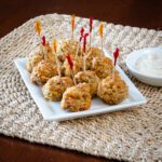 sausage balls on a plate with dip on the side