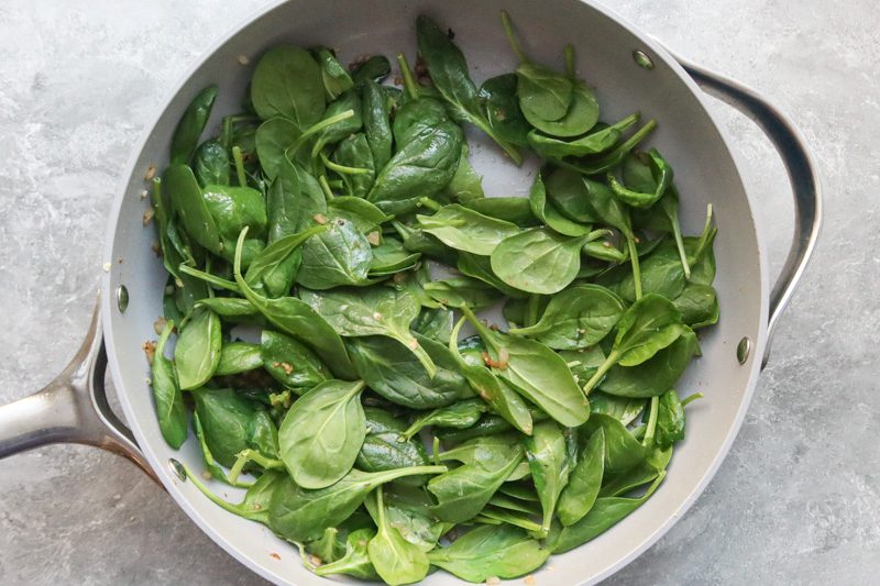 spinach and aromatics in the pan