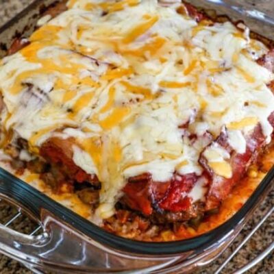 seven layer ground beef casserole with melted cheese on top