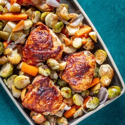 Roasted chicken thighs with roasted Brussels sprouts and carrots.