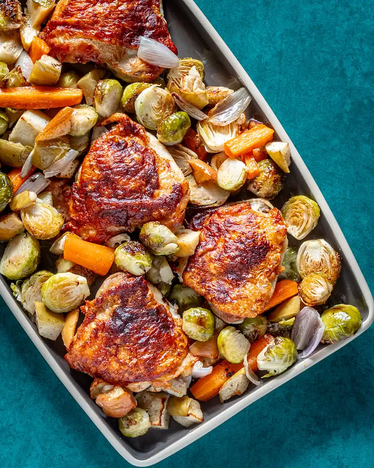Roasted chicken thighs with roasted Brussels sprouts and carrots.