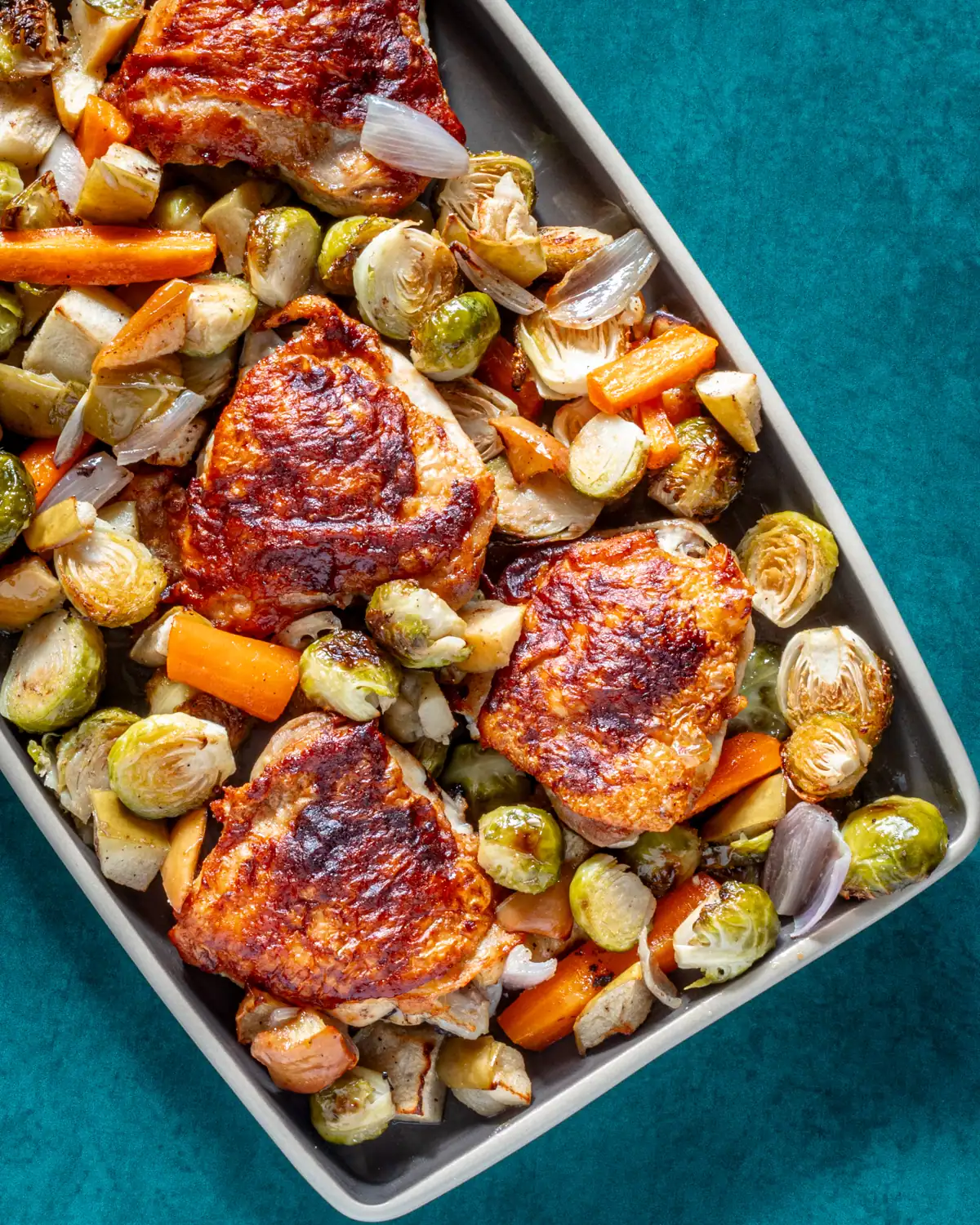 Roasted chicken thighs with roasted Brussels sprouts and carrots.