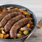 sheet pan sausages with vegetables—squash, sweet potatoes, brussels sprouts, and pears