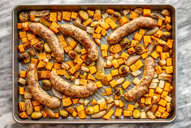 Sausages and veggies on a rimmed sheet pan, roasted to perfection.