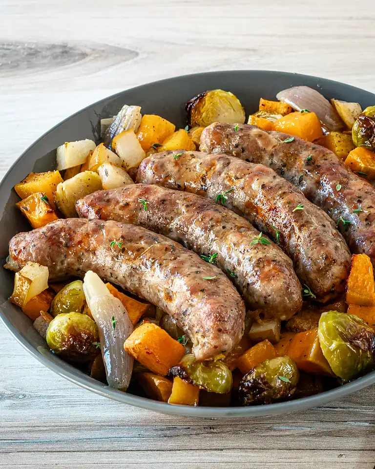 Sauteed chicken sausages with roasted vegetables, squash, sweet potatoes, zucchini, and Brussels sprouts.