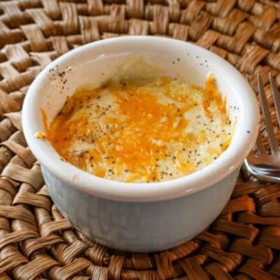 shirred eggs with cheese in a ramekin