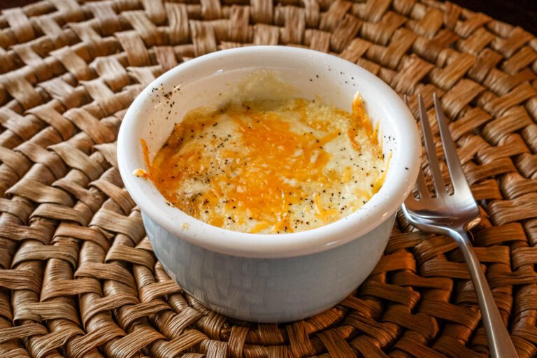 shirred eggs with cheese in a ramekin