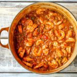 shrimp creole, shrimp and tomatoes in a dutch oven