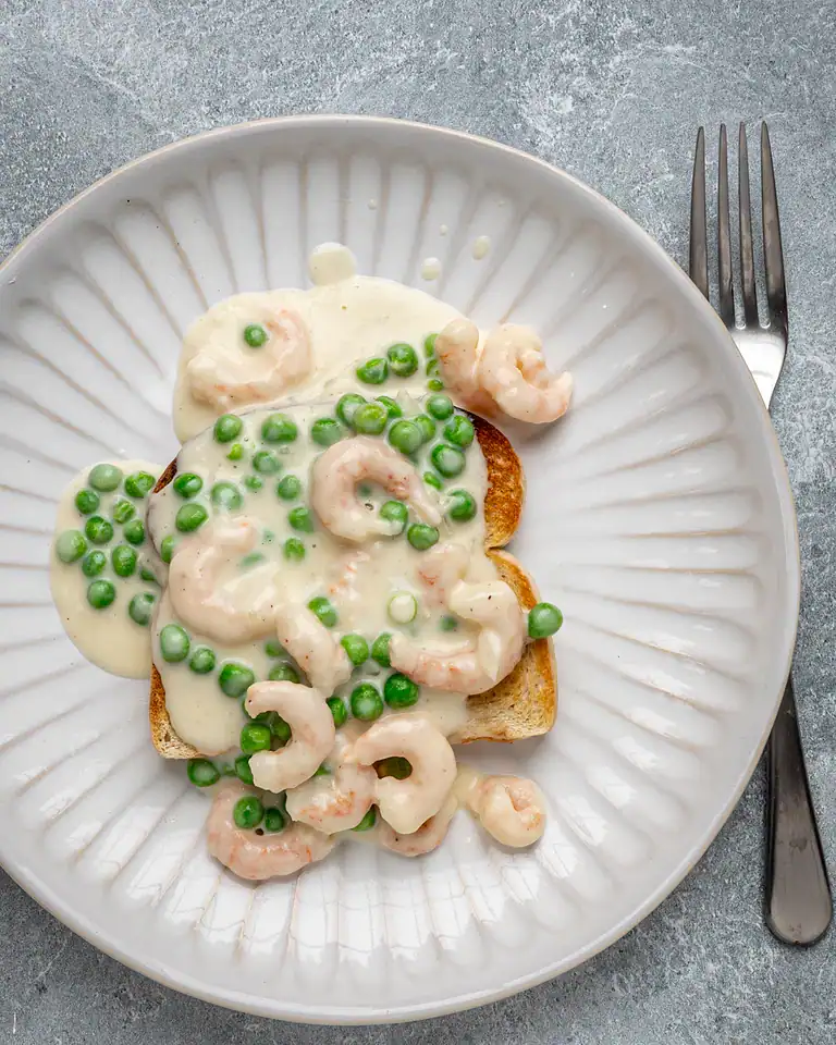 Creamy shrimp and green pea sauce over toasted bread slices.