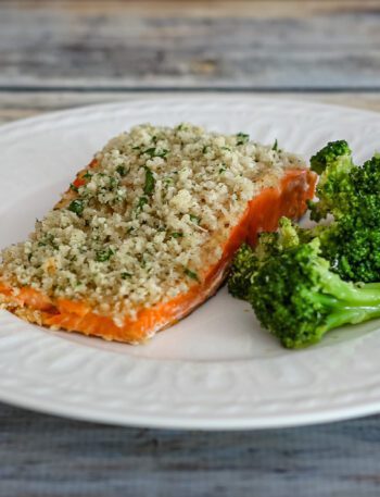broccoli with lemon shown with a salmon fillet on a plate