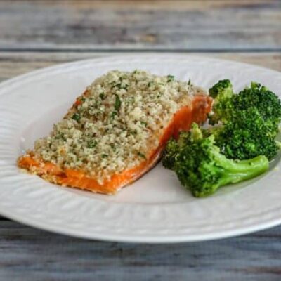 broccoli with lemon shown with a salmon fillet on a plate