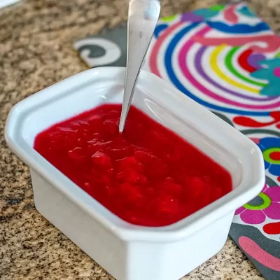 Fresh strawberry jam in a white bowl.
