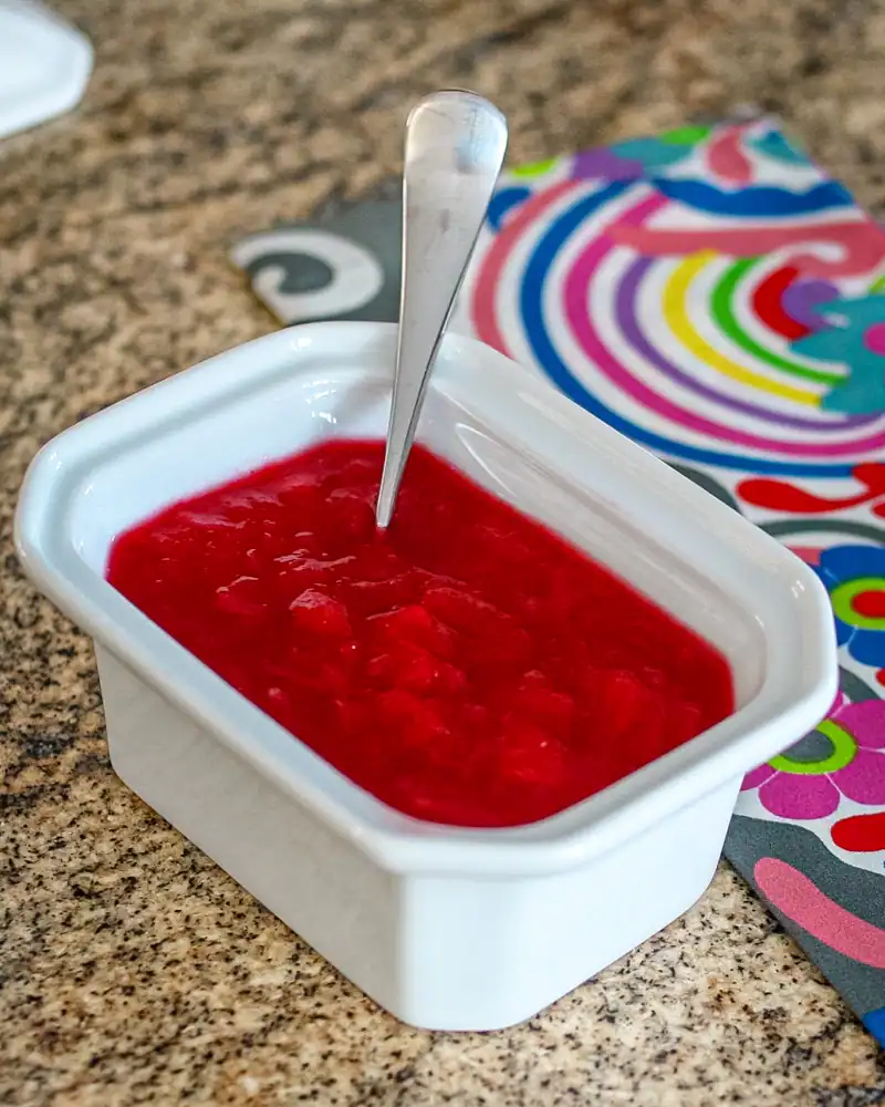 Fresh strawberry jam in a white bowl.