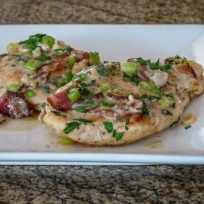 chicken with bacon and sour cream sauce on a serving plate