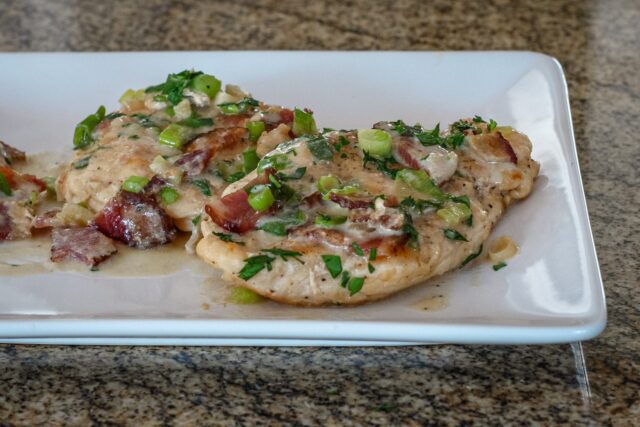 chicken with bacon and sour cream sauce on a serving plate