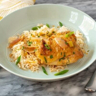 easy harissa chicken skillet shown with rice