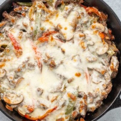 philly cheesesteak skillet in an iron skillet with cheese