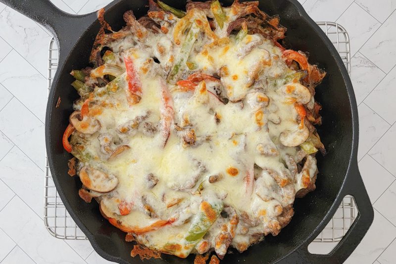 philly cheesesteak in a skillet after broiling