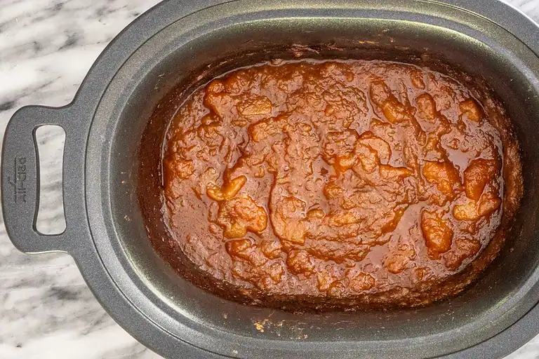 Rich simmered tomato sauce in a slow cooker.