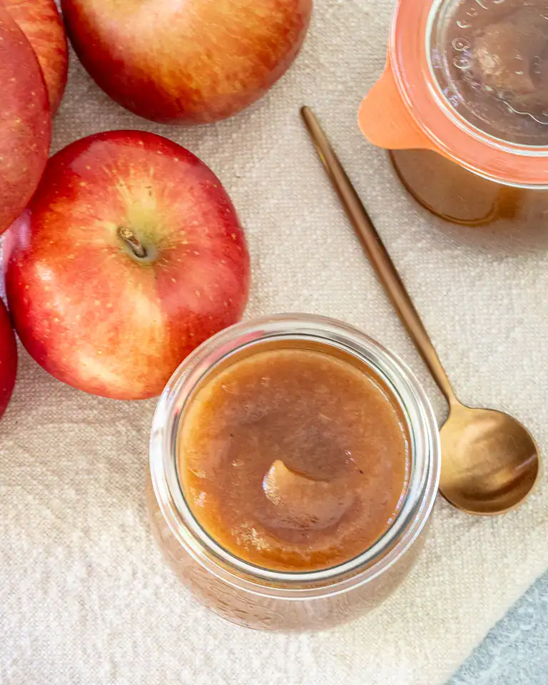 Fresh apples with caramel sauce in a jar.