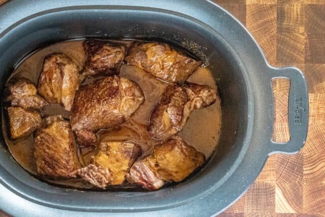 Barbacoa prep: cooked chunks in the slow cooker, ready to shred.