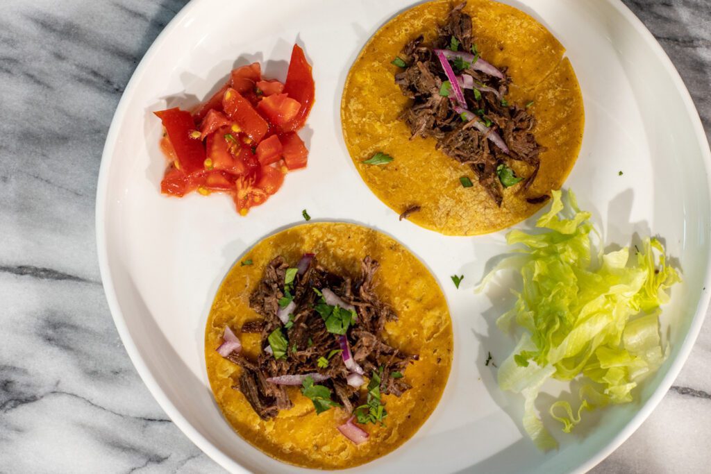 barbacoa beef on corn tortillas