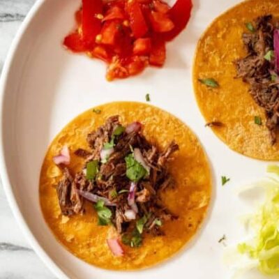 slow cooker barbacoa shredded on tortillas