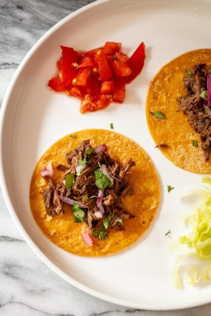 slow cooker barbacoa shredded on tortillas