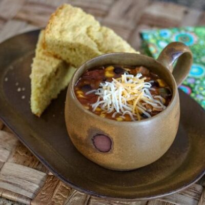 slow cooker chicken enchilada soup and cornbread on a serving tray