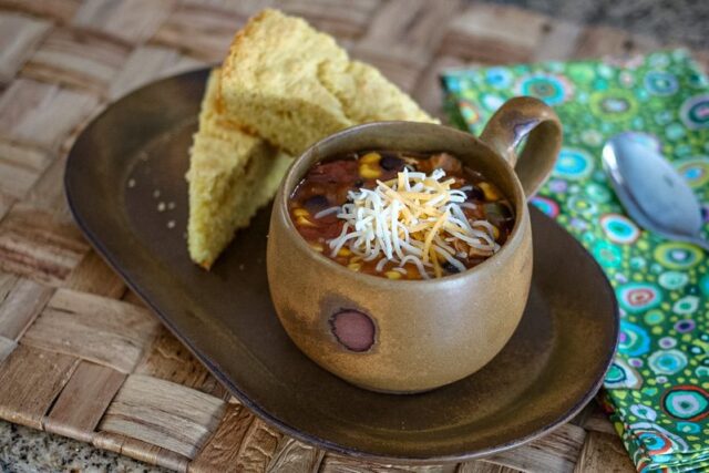 slow cooker chicken enchilada soup and cornbread on a serving tray