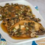 slow cooker chicken marsala with chicken breasts and mushrooms on a serving tray