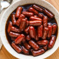 Sweet and sticky glazed sausages in dark sauce.