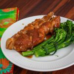 slow cooker country style ribs, on plate with broccolini