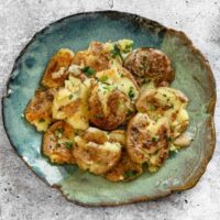 Cremini mushrooms with baked cheese and herbs.