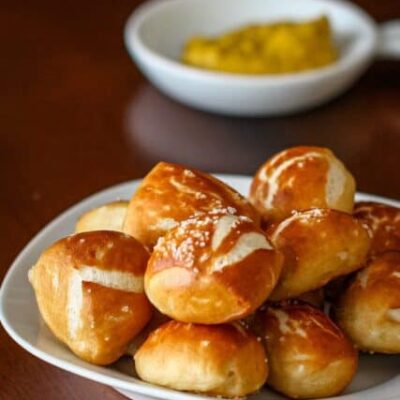 soft pretzel bites with mustard for dipping in the background