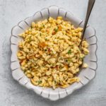 homemade sautéed spaetzle in a serving dish with spoon