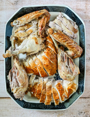 A carved spatchcocked turkey on a large platter.