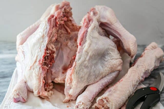 cut the backbone out of the turkey with sharp shears
