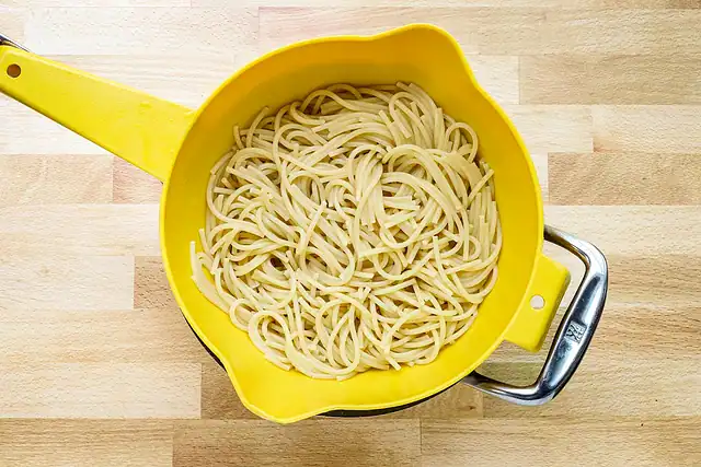 Draining pasta for tetrazzini.