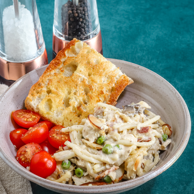 Fettuccine Alfredo with cherry tomatoes and garlic bread.