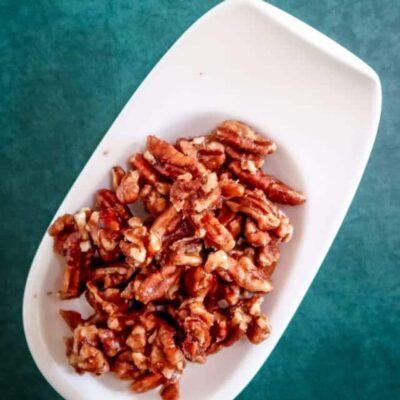 Crumbled cooked bacon on white serving dish.