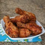 spicy fried chicken drumsticks in a serving dish