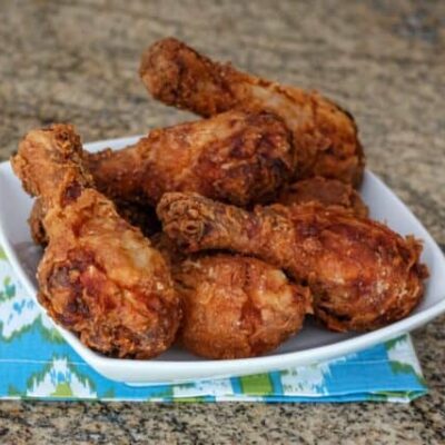 fried chicken drumsticks in a serving dish
