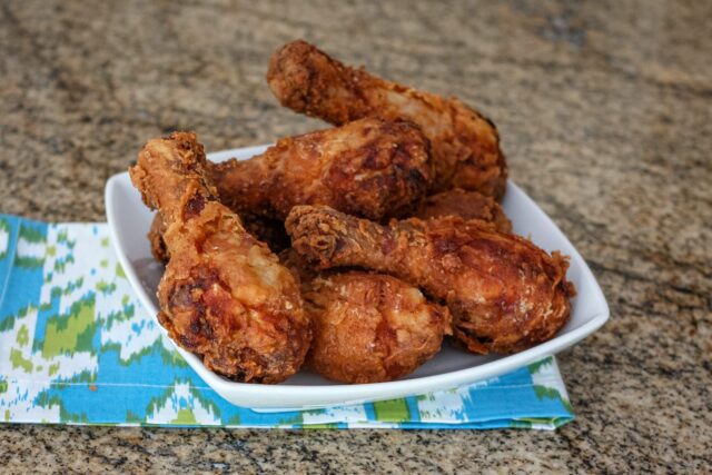 fried chicken drumsticks in a serving dish