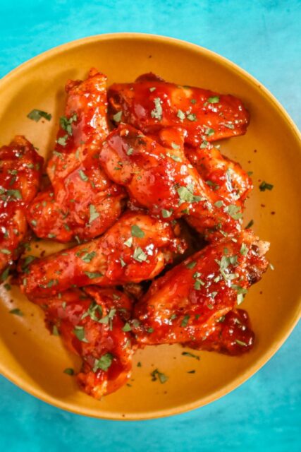 air fryer chicken wings with Korean inspired sauce in a bowl