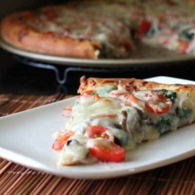 ham and spinach pizza on a plate